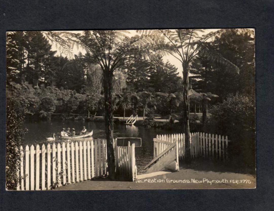 Real Photograph by Radcliffe of Recreation Grounds, Pukekura Park, New Plymouth. View thru gate of four people in a dinghy. - 47 image 0