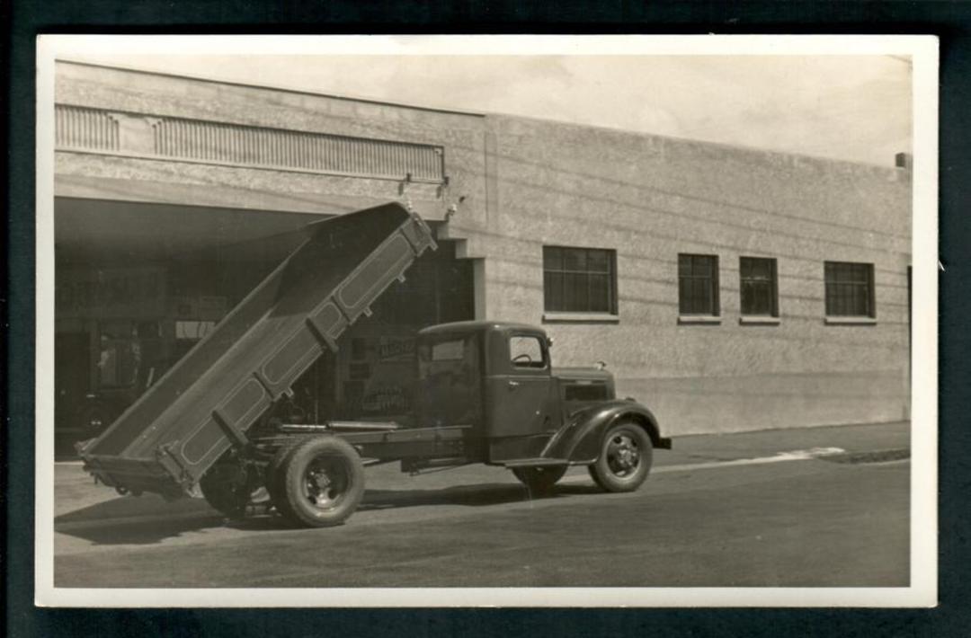 Superb Real Photograph of Tip Truck at Jolly and Mills Service Station Palmerston North. - 49701 - Postcard image 0