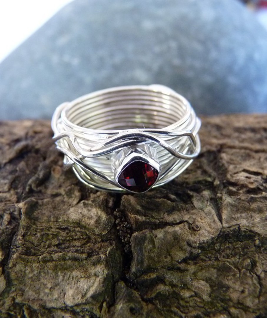 Wide silver band with sparkling garnet set in the top image 2