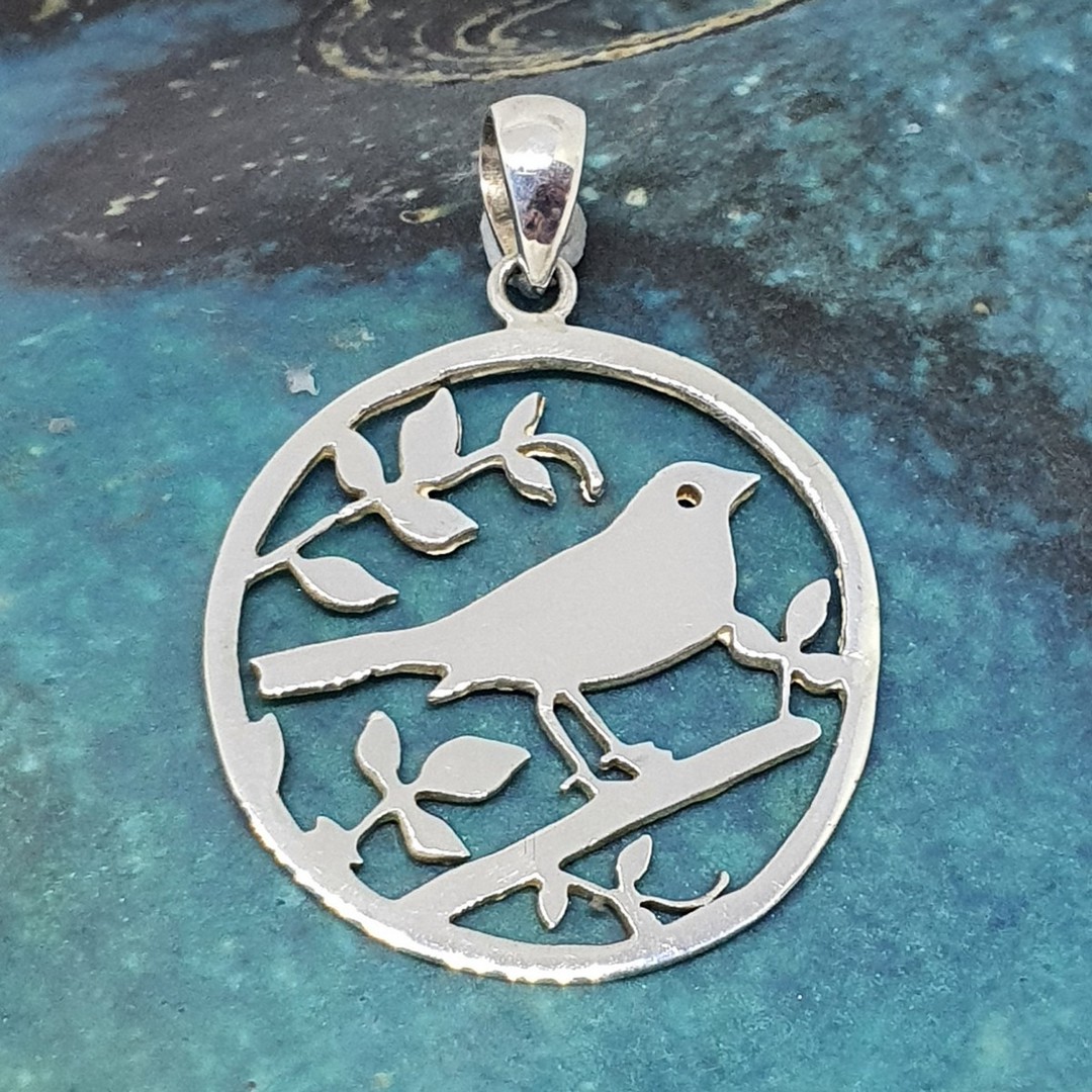 Silver pendant with a bird in a tree image 0