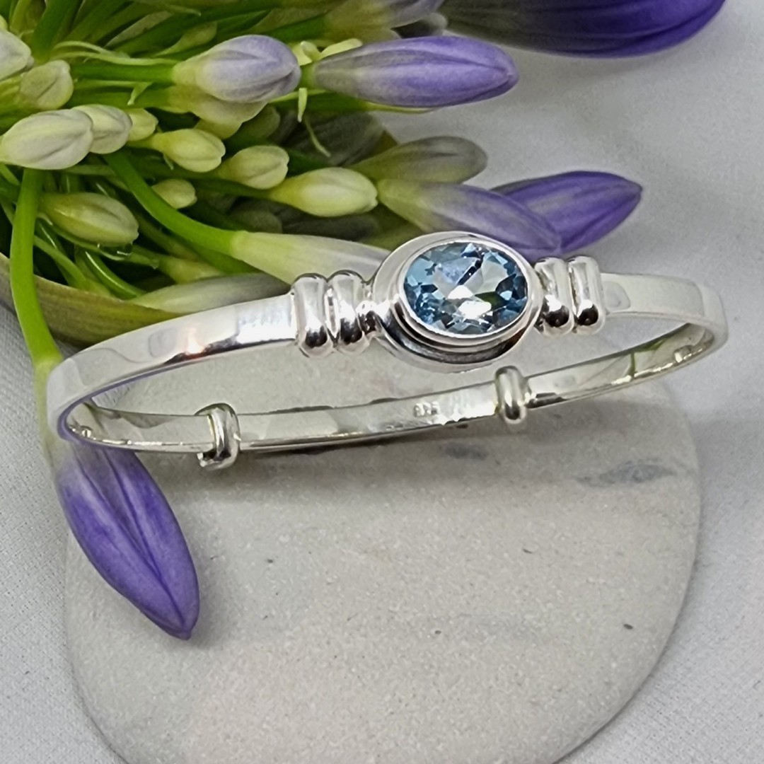 Silver adjustable baby bangle with blue topaz image 1