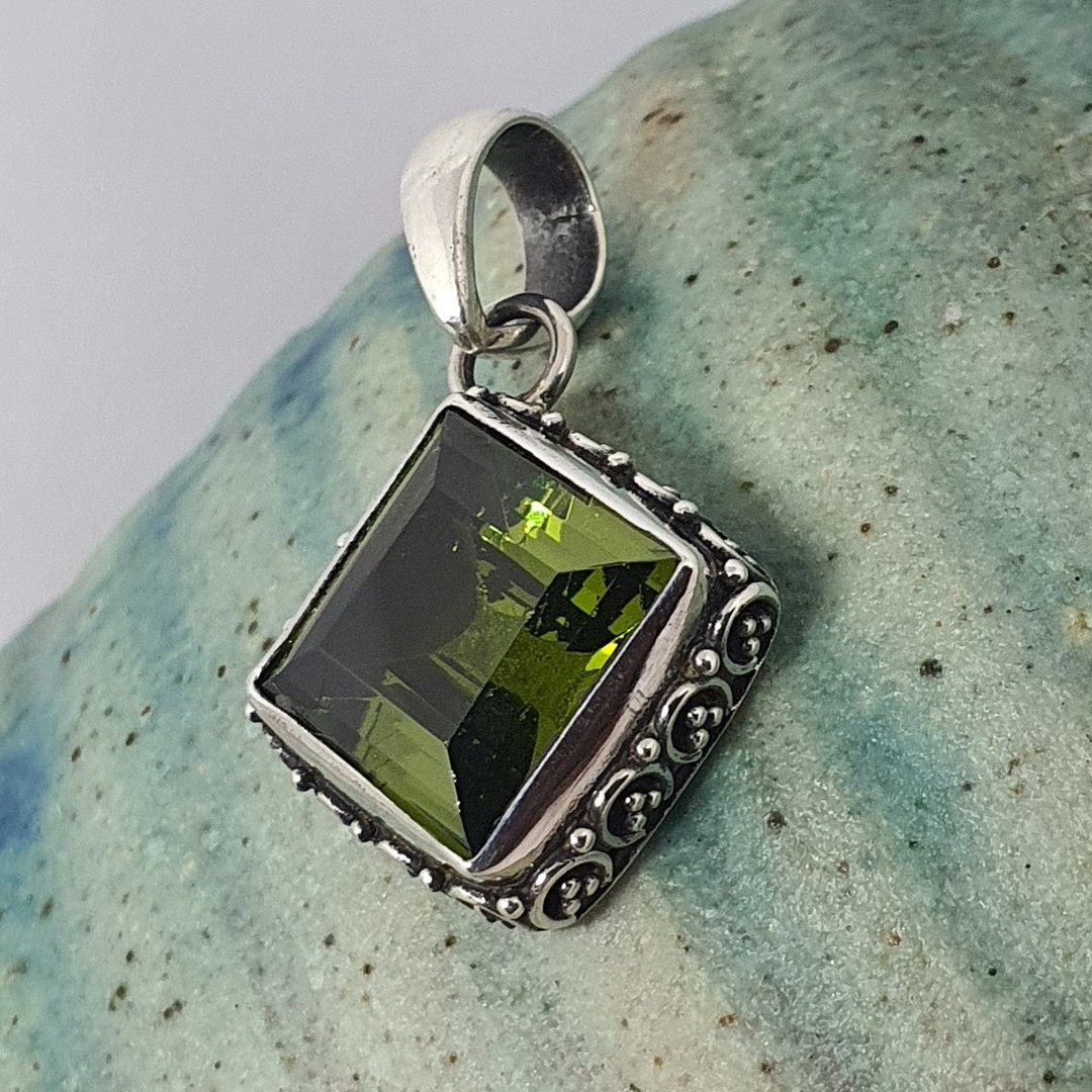 Silver peridot pendant with filigree frame image 1