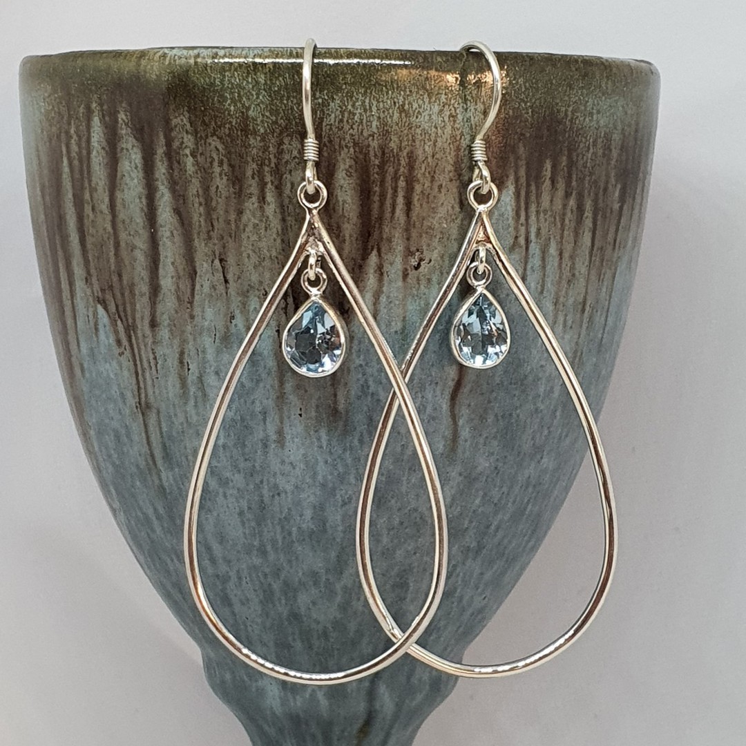 Oval silver hook earrings with blue topaz image 1