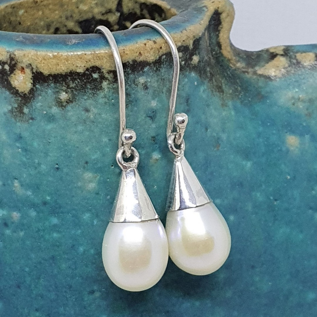White pearl earrings set in sterling silver cup image 0