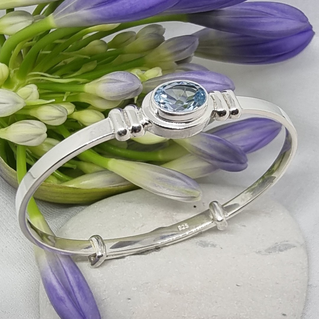 Silver adjustable baby bangle with blue topaz image 0