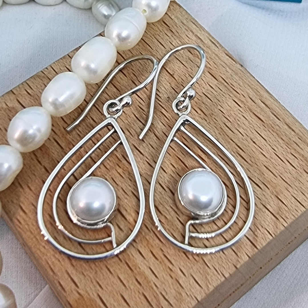 Teardrop white pearl earrings with open silver frame image 0