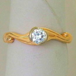 R308 Diamond and koru engagement ring set in yellow Gold.