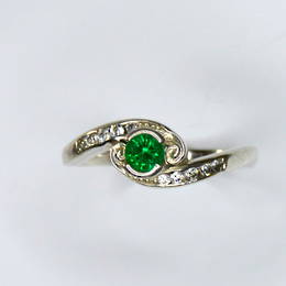 R362 Emerald and Diamond crossover style koru engagement ring