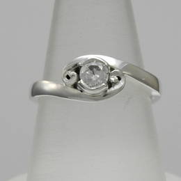 R362 Single Diamond crossover style koru engagement ring in