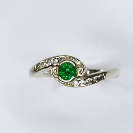 R362 Emerald and Diamond crossover style koru engagement ring
