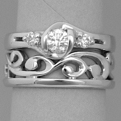 Bespoke platinum and diamond engagement ring inspired by Maori fish-hook  shapes