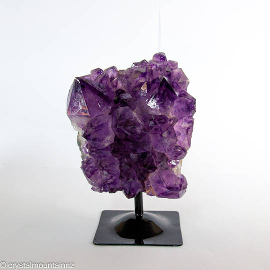 Amethyst Druze on a black metal stand.