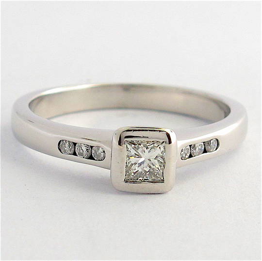 18ct white gold diamond solitaire ring with channel set diamond shoulder detail