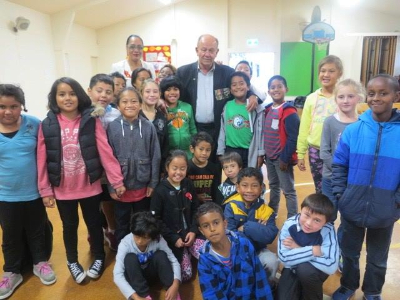 Graham Gibson surrounded by pupils from May Rd school