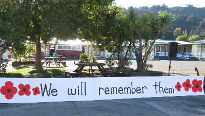 Banner at school reads We Will Remember Them 