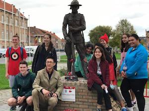 Students with the soldier statue at Messines