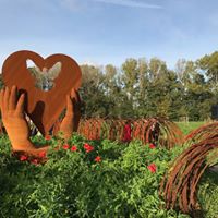 Sculpture in field of poppies