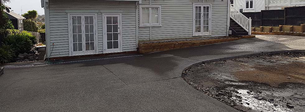 Concrete driveway freshly installed for a happy client in Kohimarama