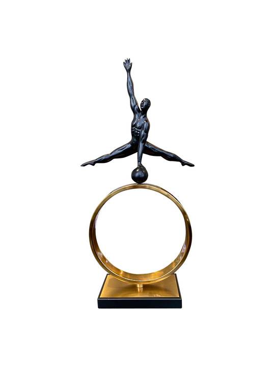 GYMNAST SPLITS ON METAL OBJECT