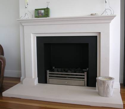 Classical linear styling with carved moulded mantle and foot blocks, carved in Portuguese Limestone