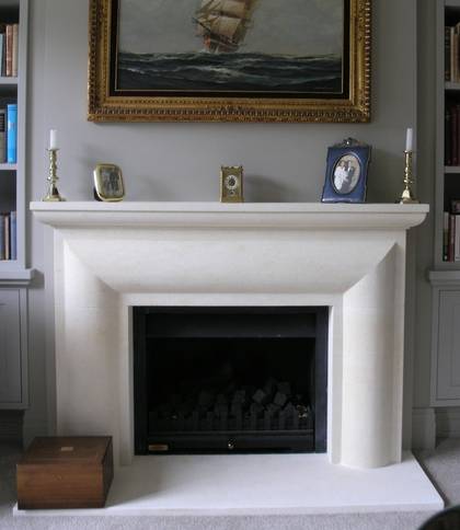 Bolection with carved moulded mantle, in Oamaru Limestone
