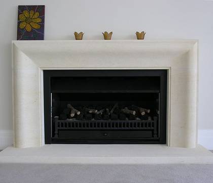 Contemporary fire surround 'connecting curve' design hand carved in Oamaru Limestone