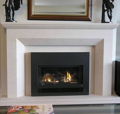 Contemporary designed fireplace with bevel to internal edge, carved in Portuguese Limestone