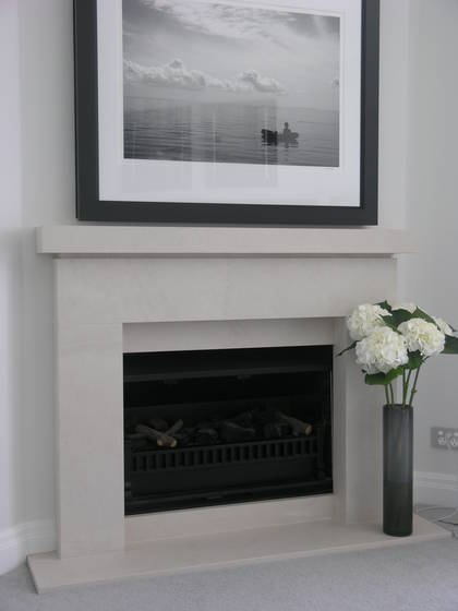 Contemporay Cubist design with negative detail to mantle carved in Portuguese limestone