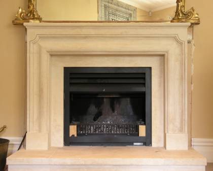 French Louis XIII fireplace carved in Oamaru Limestone with aged patina