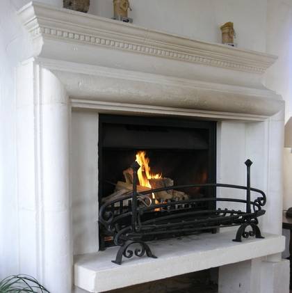 French Louis XIII raised hearth hand carved in Oamaru Limestone with aged and 'distressed' patina finish
