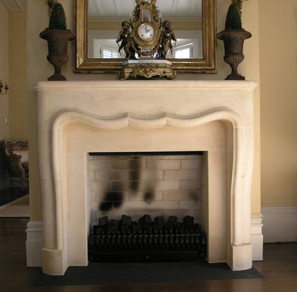French Louis XIV style fire surround hand carved in Oamaru stone with aged patina wash