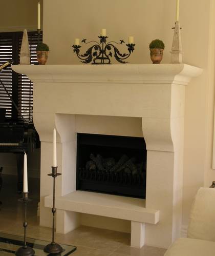 Italianesque styled fireplace mantle with raised hearth carved in Oamaru Limestone