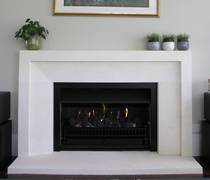 Bevel fireplace with wide border, carved in Oamaru Limestone