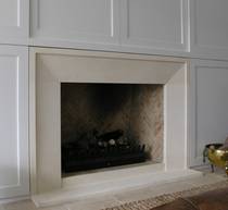 Bevel fireplace with small border style fire surround carved in Oamaru Limestone