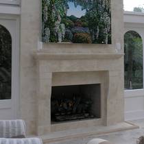 French Provincial fireplace and breast in loggia setting, set into aged Oamaru Stone wall