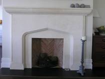 Victorian Gothic revival fire surround carved in Oamaru limestone with lightly aged patina