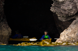 Sea-kayaks inside a sea-cave on the outer coast f banks peninsula