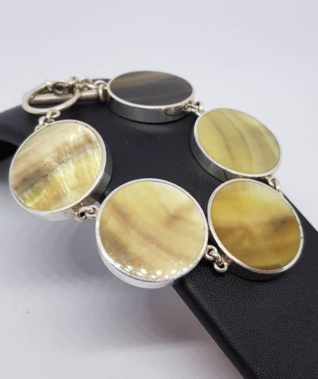 Gold toned shell and silver bracelet