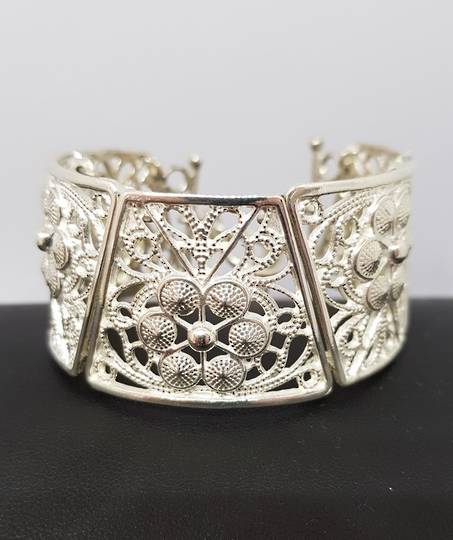 Chunky silver NZ made bracelet with carved flowers and swirls