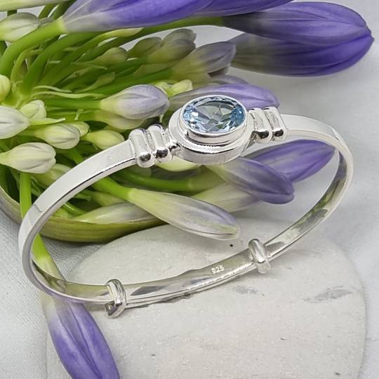 Silver adjustable baby bangle with blue topaz