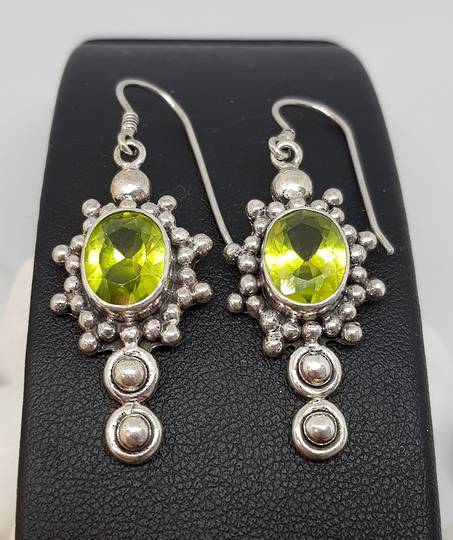 Large ornate silver peridot earrings with a gorgeous