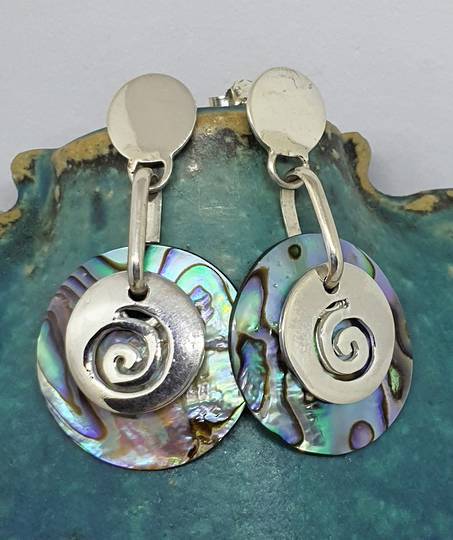Round silver paua shell earrings with silver koru disc