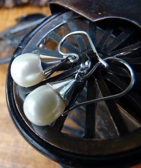 White pearl earrings set in sterling silver cup