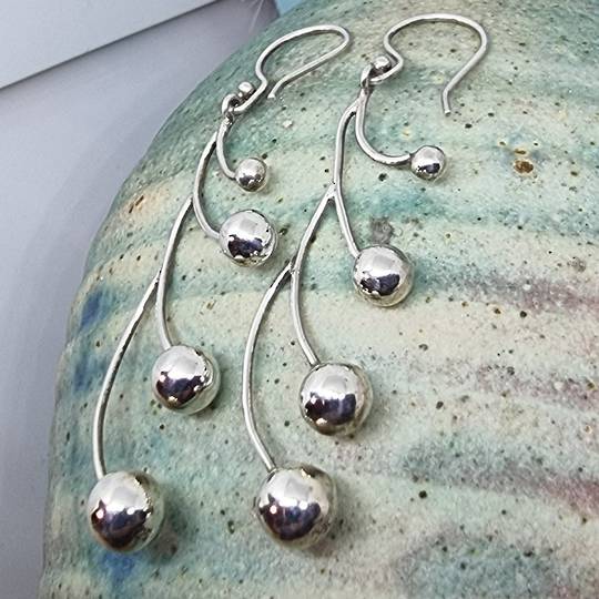 Long silver multi sphere earrings