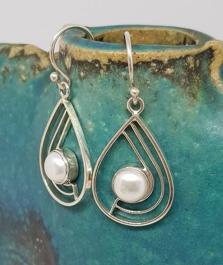 Teardrop white pearl earrings with open silver frame