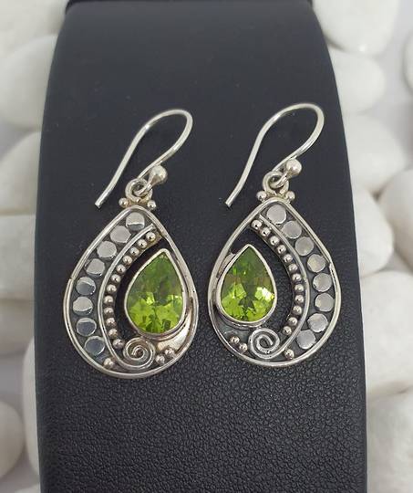 Silver peridot earrings in open teardrop shape