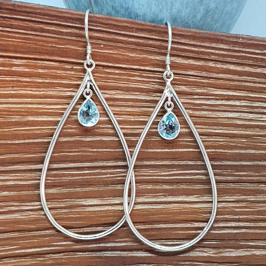 Oval silver hook earrings with blue topaz