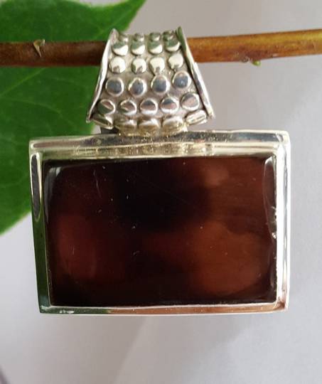 Brown shell pendant with heavy detailed bale