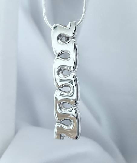 Curved wave of sterling silver pendant