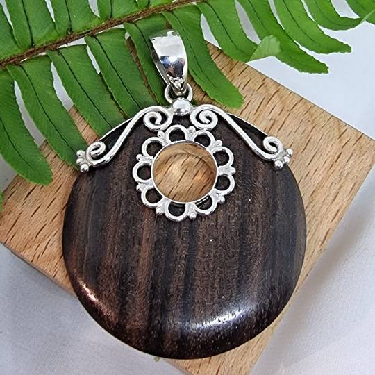 Polished wooden pendant with silver detailing - now on sale
